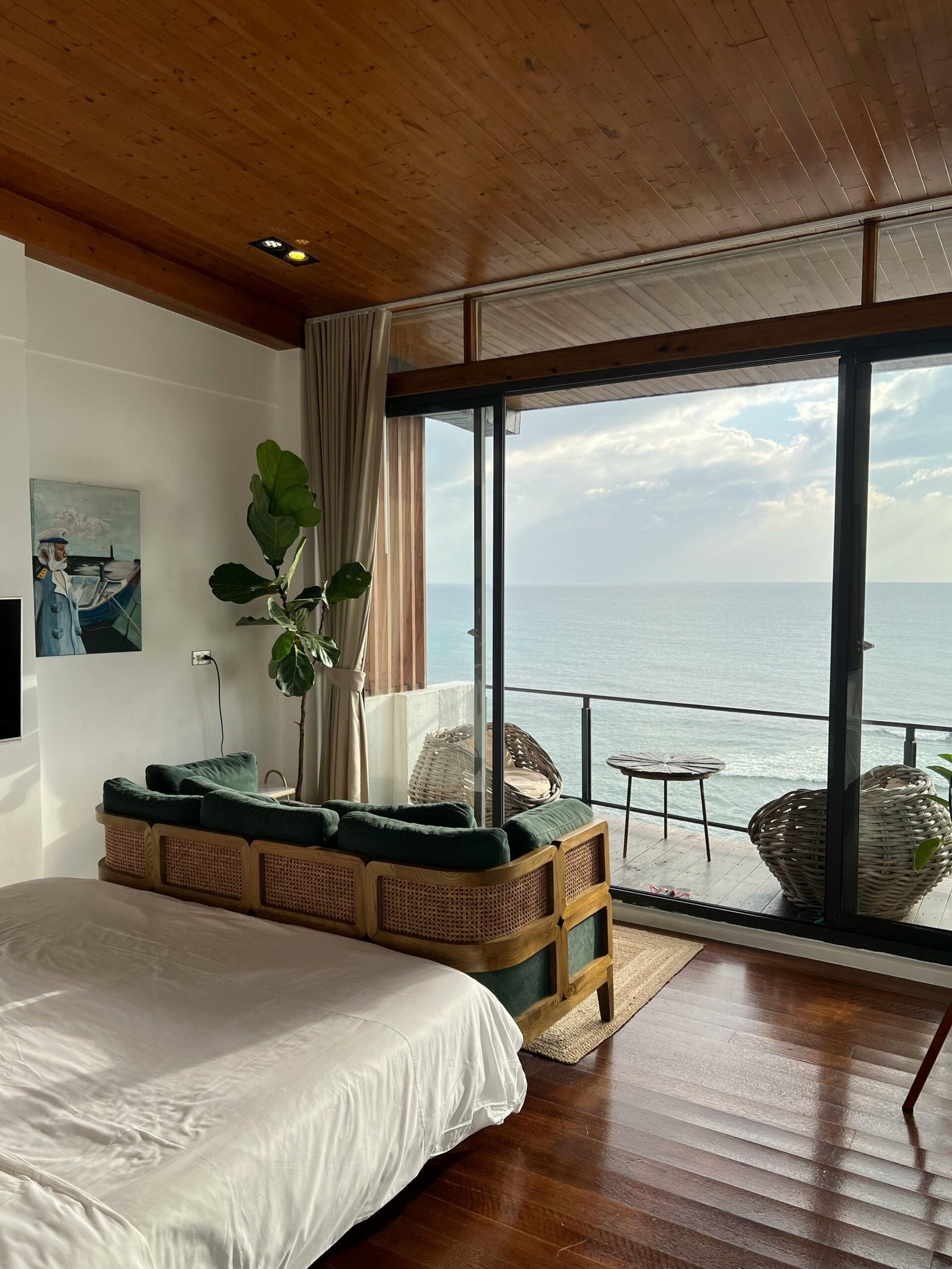 A stylish hotel room with balcony and stunning sea view, perfect for a relaxing summer vacation.